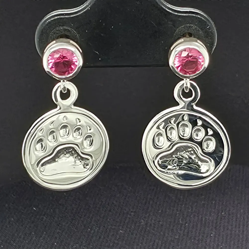 Close detail of the bear print earrings in silver with faceted gemstone studs